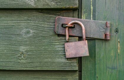 Padlock on wooden gate